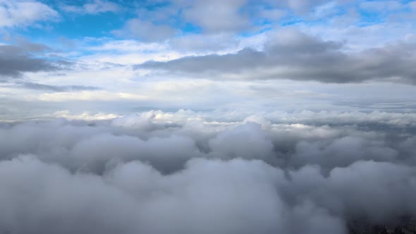 Aerial View From Airplane Window at High Altitude of Earth Covered with Puffy Cumulus Clouds Forming