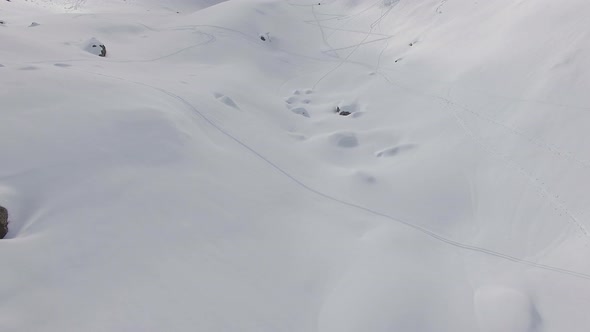 Aerial view of skiers on snow covered mountains.