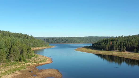 Aerial ascending and flying away from Clear Lake in the Mount Hood wilderness area in Oregon.