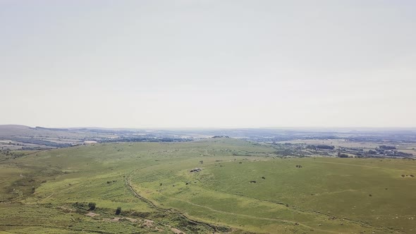 Zooming out over the landscape of Dartmoor National Park. Aerial view of the farmland in the nationa