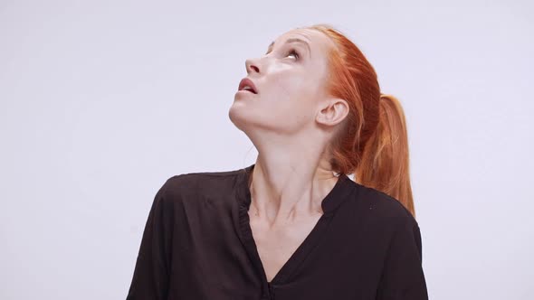 Surprised Young Caucasian Woman with Colored Orange Hair Standing in White Background in Dark Brown