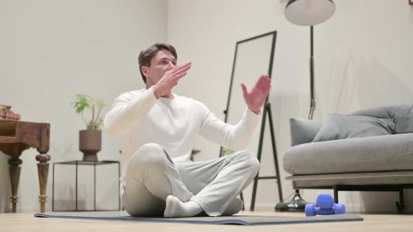 Hands of Man Meditating on Yoga Mat at Home