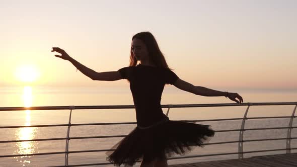 A Ballerina Practicing a Ballet Dance Near the Sea
