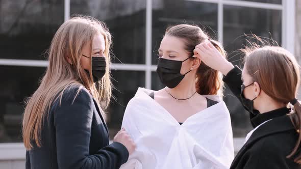 Three Pretty Girlfriends Are Putting Protective Masks On.