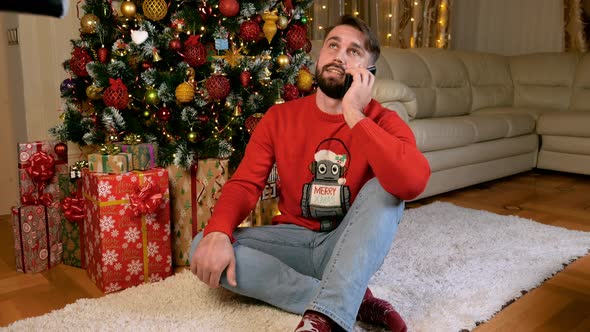 Young Caucasian Man Calling in Christmas Eve