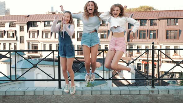 Three young female hipster friends posing outdoors