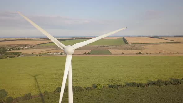 Aerial view of wind turbine generators in field producing clean ecological electricity.