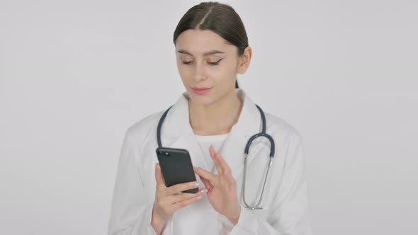 Spanish Female Doctor using Smartphone on White Background
