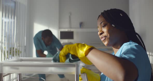 Diverse Team of Hospital Janitors Cleaning and Disinfecting Room