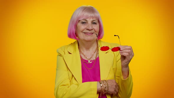 Happy Playful Stylish Senior Granny Woman in Sunglasses Blinking Eye Looking at Camera with Smile