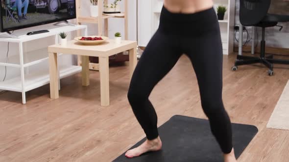 Young Woman Doing Jumping Jacks To Lose Weight