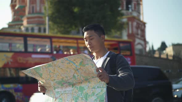 Left To Right Pan Real Time Portrait Shot of a Young Tourist Looking for Attractions in Moscow with