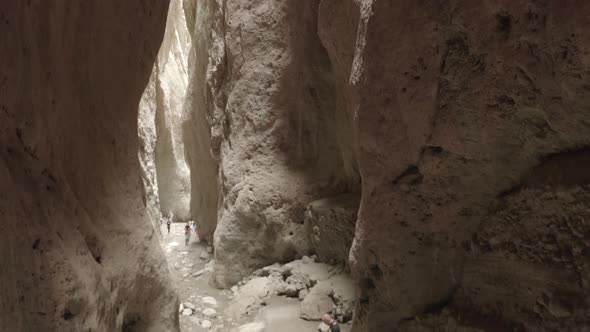 Drone Flying Through Narrow Canyon in Mountains