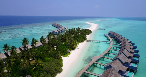 Tropical overhead tourism shot of a summer white paradise sand beach and blue sea background in vibr