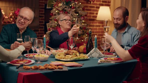 Festive Diverse People Clinking Glasses While Enjoying Christmas Dinner Table