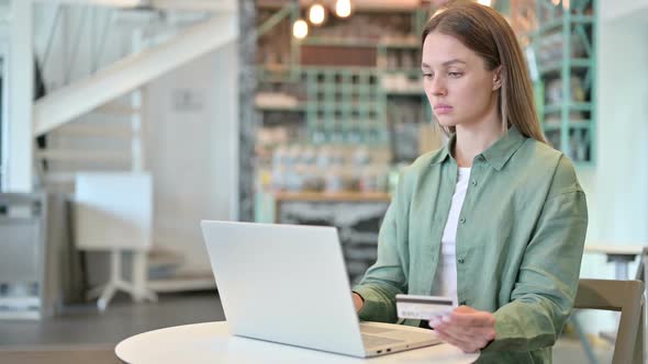 Woman Having Online Payment Failure on Laptop in Cafe