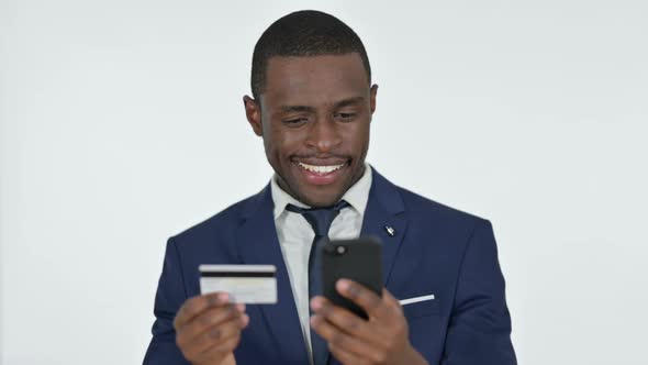 Online Shopping on Smartphone By African Businessman White Background