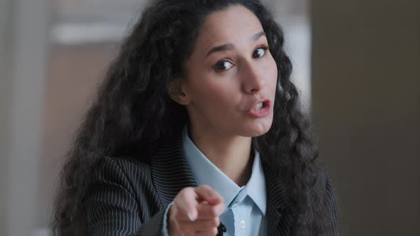 Arabian Smiling Curly Woman Employee Business Lady Pointing Index Finger at Camera Emotionally