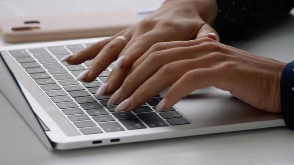 Female Hands Typing on Notebook Keyboard