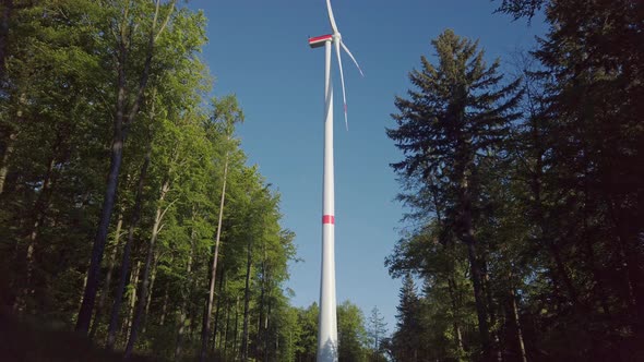 Real time shot of wind turbines against blue sky