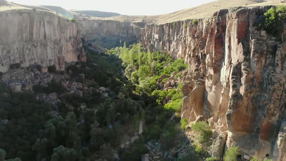 Aerial Deep Long Rift Canyon with Cleft Steep Rock Walls and High Cliff Gorge