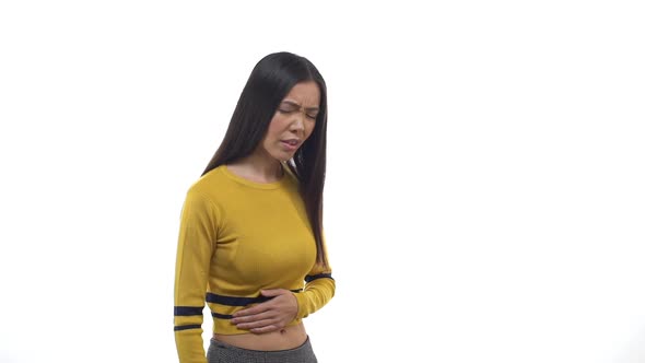 Slow Motion Young East Asian Cute Girl Wearing Cropped Top Suffering Terrible Stomachache Touching