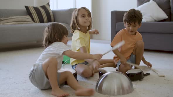 Caucasian Girl and Boys Knocking Bowls and Playing Together