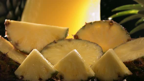 Slow Motion Shot of Pineapple and Juice Splashing Through Pineapple Slices