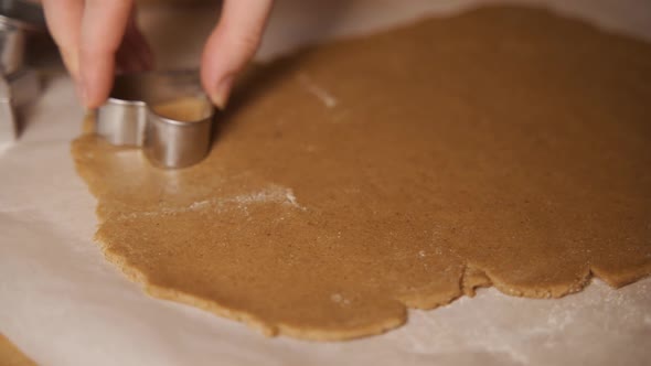 Close Up of Female Baker Hands Making Biscuits Using Baking Tin in Shape of Flower