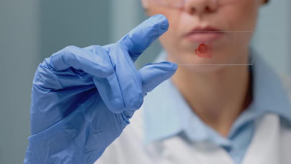 Close Up of Hand Holding Glass Tray with Blood