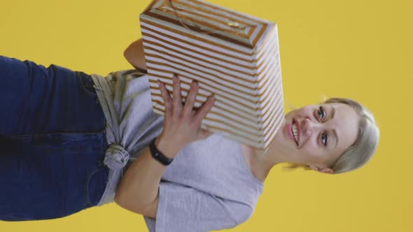 Young Woman Catching a Gift Box