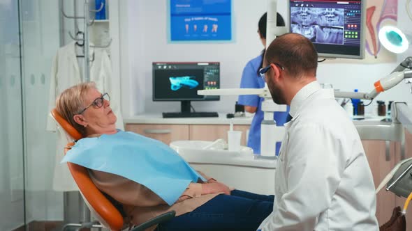 Old Woman Having Medical Treatment at Dentist Office