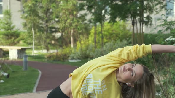 Beautiful Sporty Woman Exercises on Street