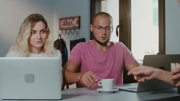 Freelancers couple working together in coffee shop with laptop  browsing online.