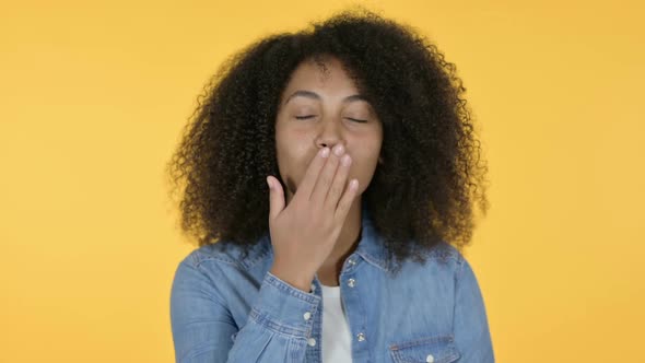 African Woman Giving Flying Kiss Yellow Background