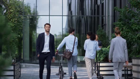 Two Employees Walking Holding Electric Scooter Rental Bicycle