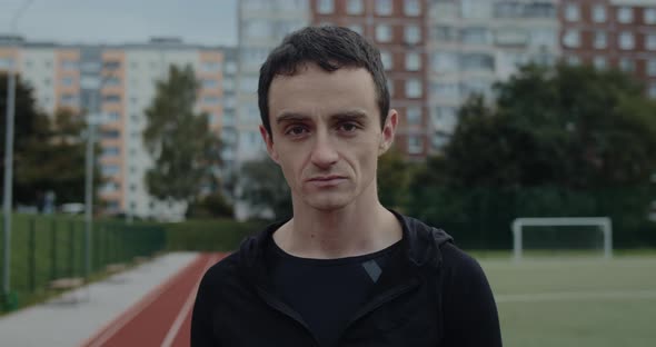 Crop View of Young Serious Man Turning Head and Looking To Camera