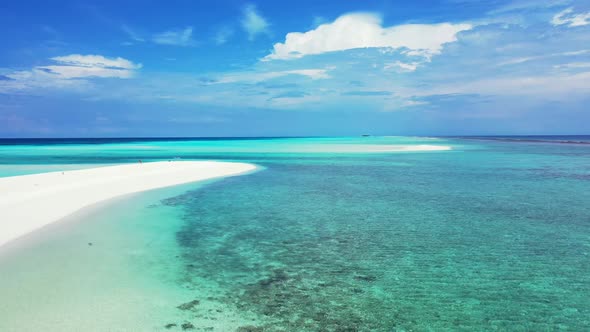 Aerial above travel of tranquil coast beach lifestyle by blue green ocean with white sand background