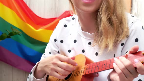 Young Millennial Hippie Woman Sitting on Balcony Play Guitar