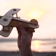 the Child Holds a Plane in His Hand Against the Setting Sun Simulates the Flight - VideoHive Item for Sale