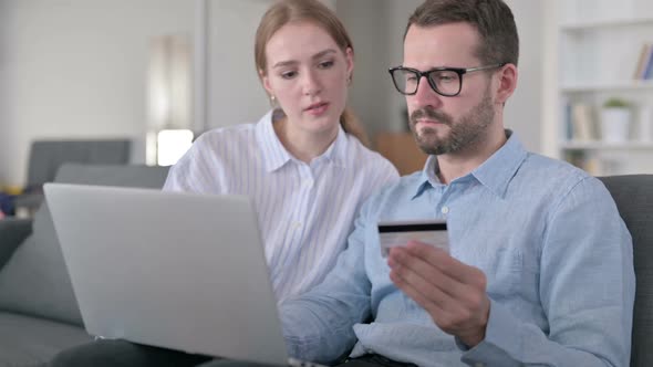 Happy Young Couple Making Successful Online Payment on Laptop