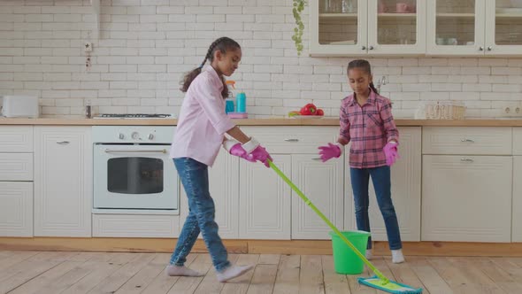 Housekeeping Mixed Race Sisters Swabbing Down Floor