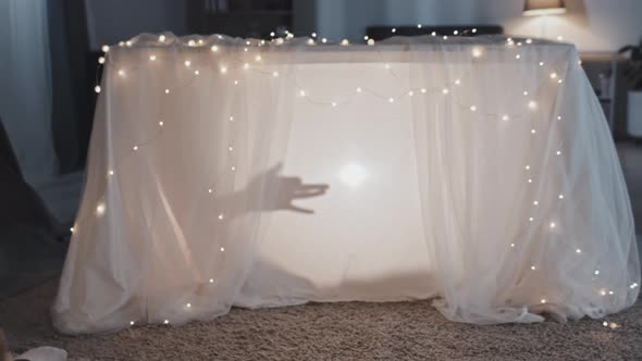 Boy and Woman Watching Shadow Puppets