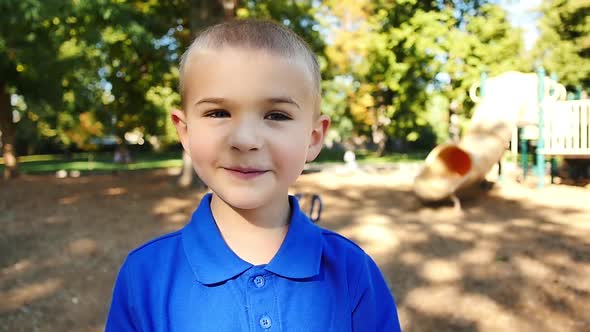 Portrait of mischievous little boy on playground