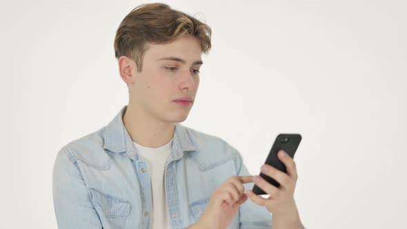 Young Man Celebrating on Smartphone on White Background