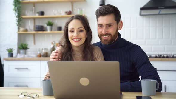 Happy Caucasian Couple Making Videocall with Friends or Parents Remotely at Home