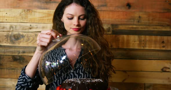 Portrait of female customer holding cake