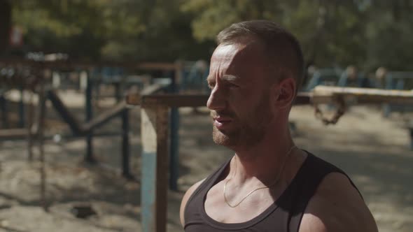 Portrait of Man Exercising with Dumbbells Outdoors