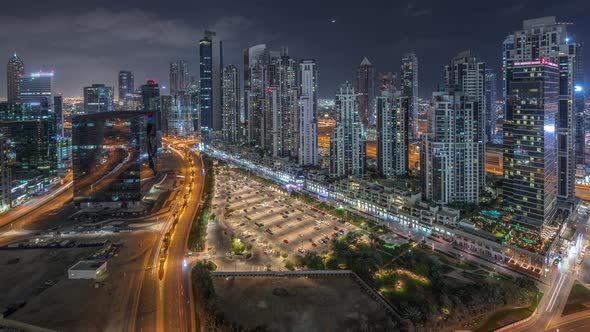 Modern Residential and Office Complex with Many Towers Aerial Night Timelapse at Business Bay Dubai