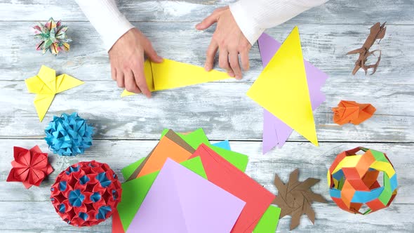 Man Folding Origami at Workplace.